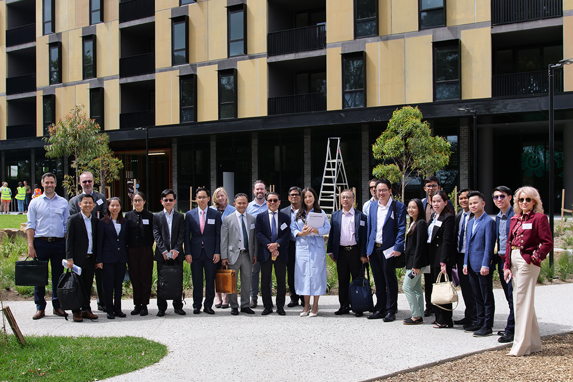 Cambodian delegates outside a social housing project in Melbourne
