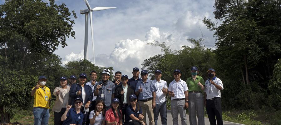 Lao PDR delegation in front of wind turbine in Thailand