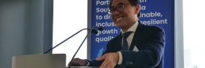 Cambodia Ministry of Economy and Finance Secretary of State, H.E. Meas Soksensan, stands at a lectern with a P4I banner behind him to deliver opening remarks